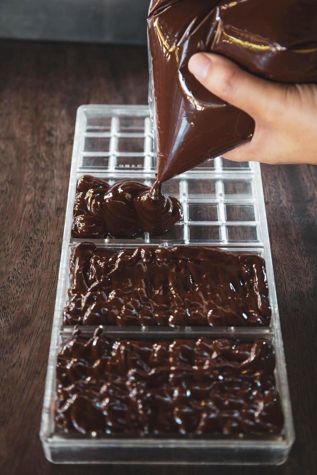 femme au foyer faisant des chocolats faits à la main à la maison photo