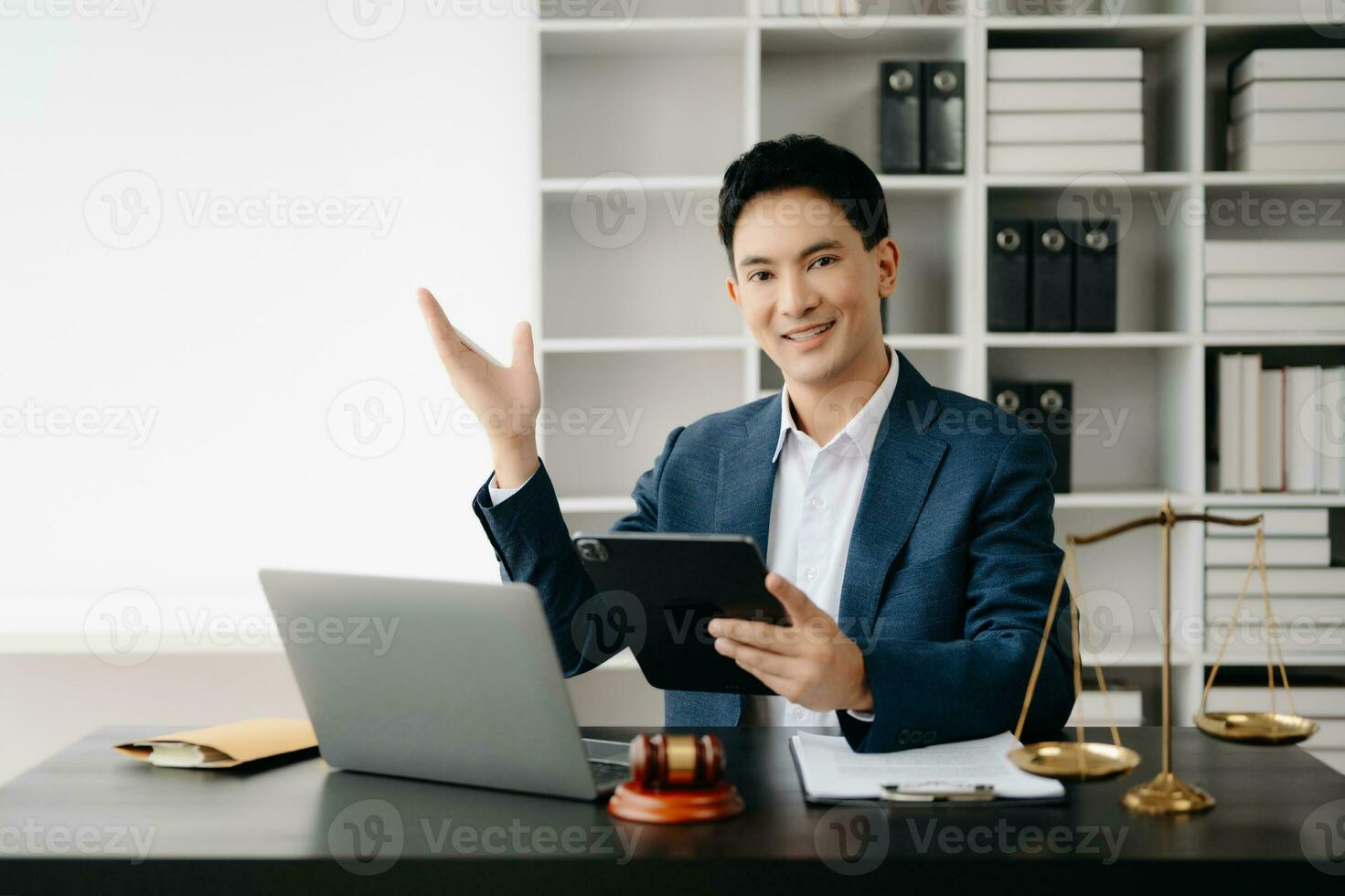 attrayant Jeune avocat dans Bureau affaires homme et avocats discuter Contrat papiers portable et tablette avec laiton échelle sur bureau dans moderne bureau. loi, légal prestations de service, conseil, photo