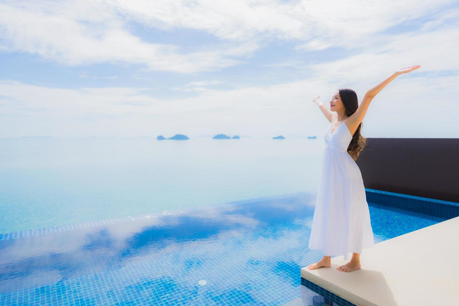 Portrait jeune femme asiatique se détendre sourire heureux autour de la piscine de l'hôtel et du complexe photo