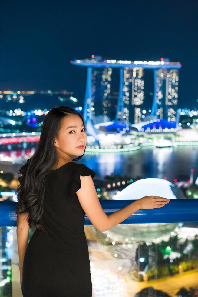 belles femmes asiatiques sourient et heureuses de la vue sur la ville de singapour photo
