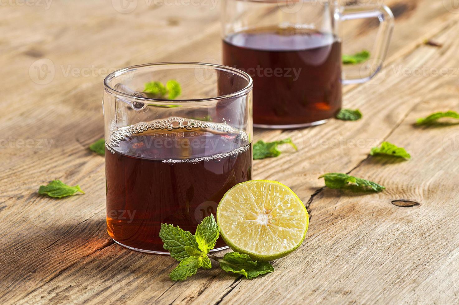 tasse de thé au gingembre, citron et menthe sur table en bois photo