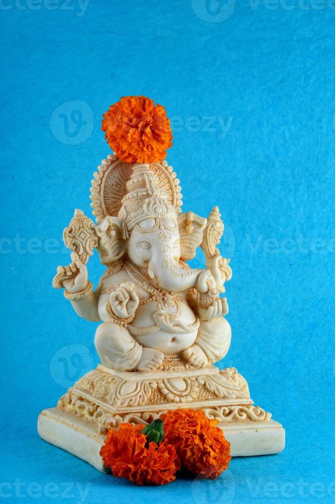 dieu hindou ganesha. idole de ganesha sur fond bleu photo