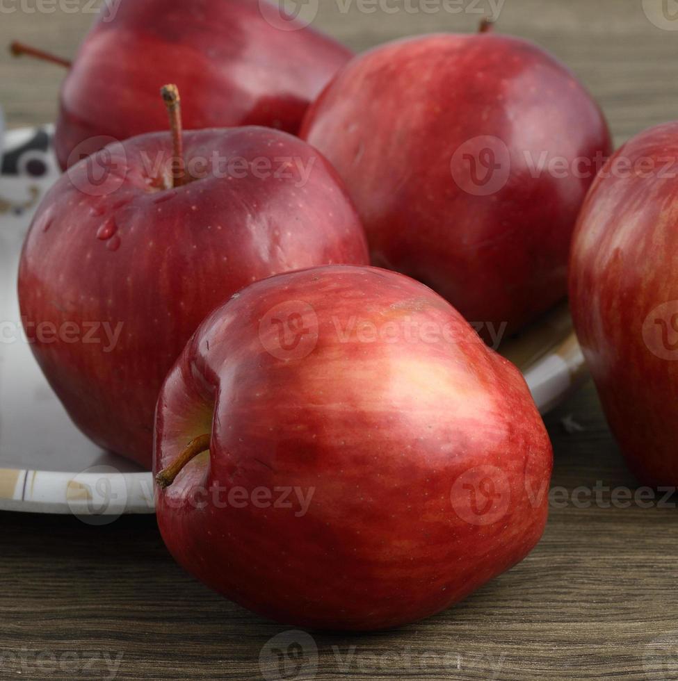 pommes rouges mûres sur fond de bois photo