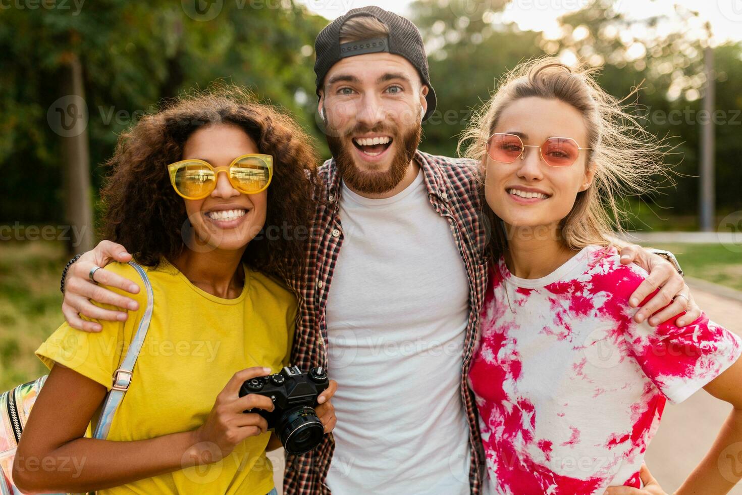 content Jeune entreprise de émotif souriant copains en marchant dans parc photo