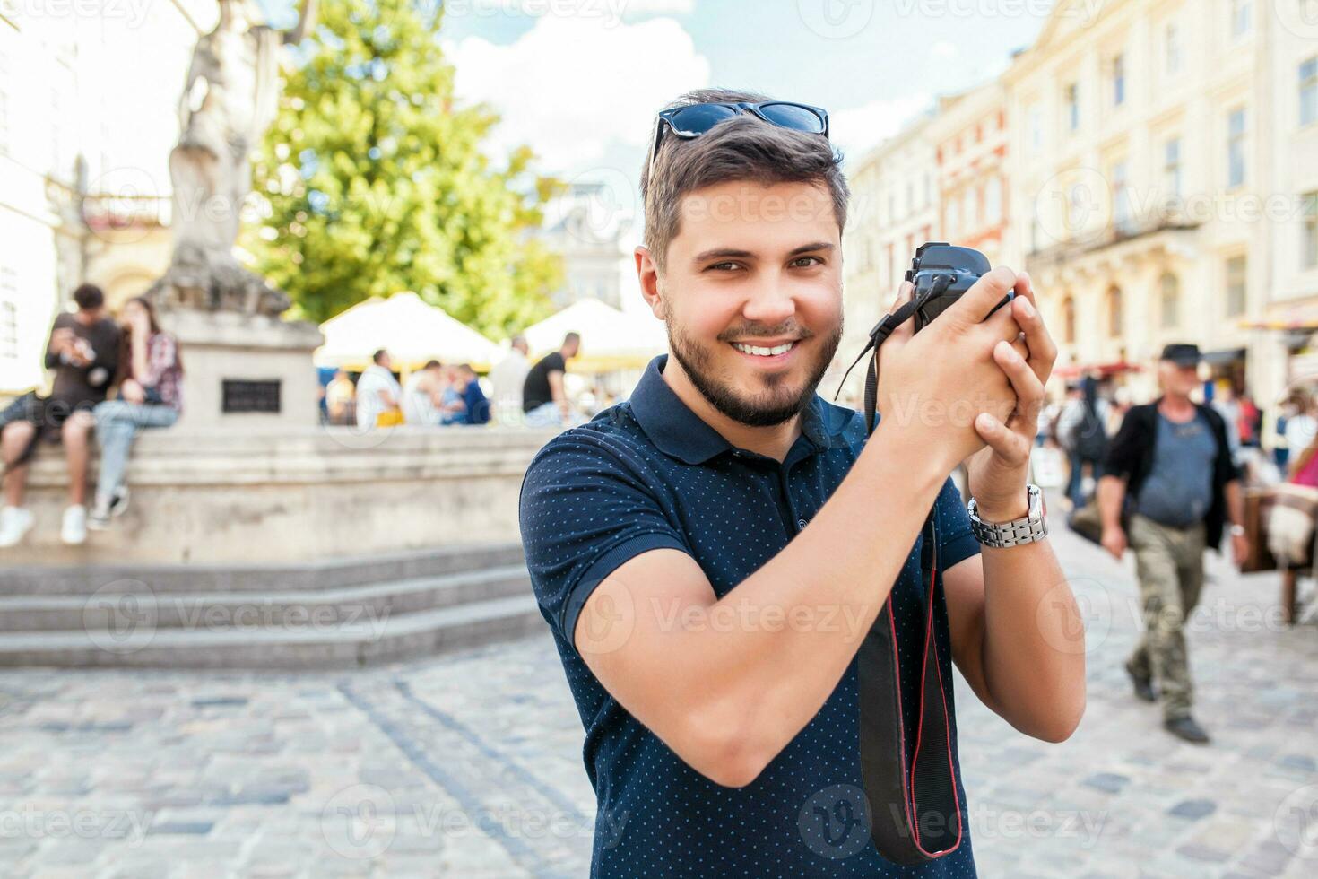 Jeune Beau branché homme en marchant avec photo caméra