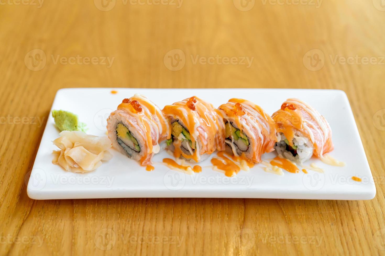 rouleau de saumon sushi avec sauce sur le dessus - style de cuisine japonaise photo