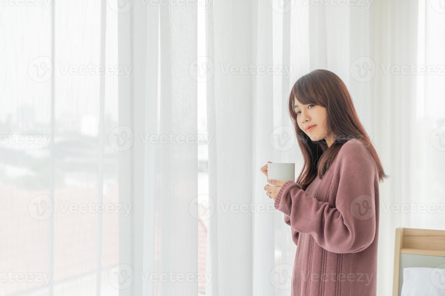 belle femme asiatique buvant du café le matin photo