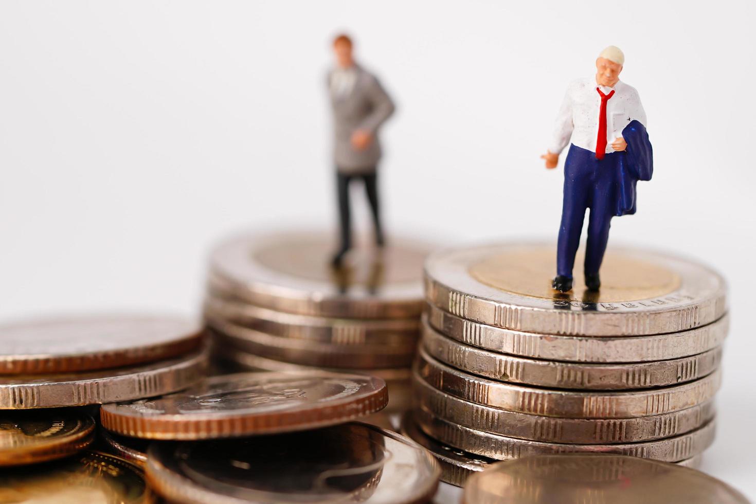 des gens miniatures d'homme d'affaires se tiennent sur une pièce de monnaie et une calculatrice, concept de gestion financière d'entreprise. photo