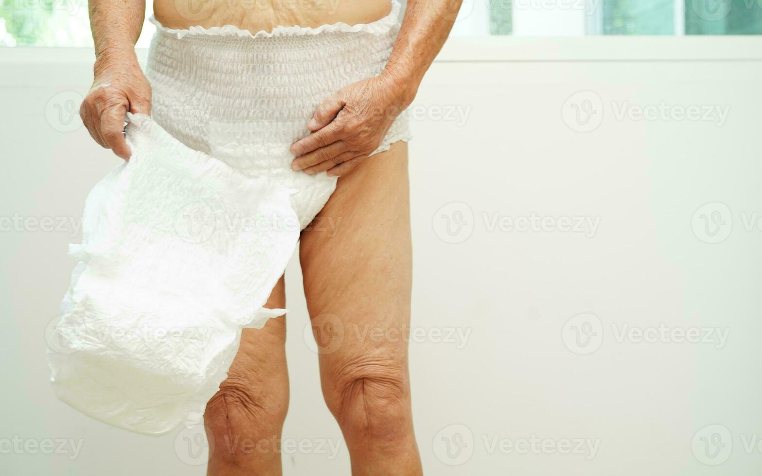 asiatique Sénior femme patient portant adulte incontinence couche tampon dans hôpital. photo