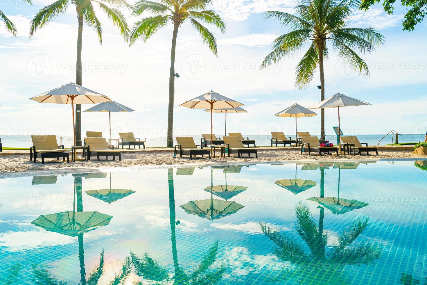 beau parasol et chaise autour de la piscine de l'hôtel et du complexe photo