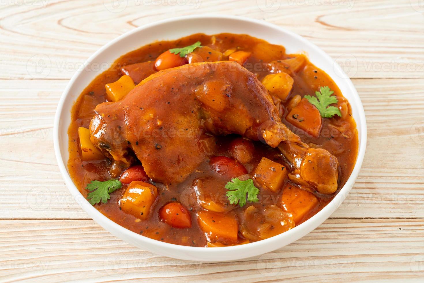 ragoût de poulet maison avec tomates, oignons, carottes et pommes de terre sur assiette photo