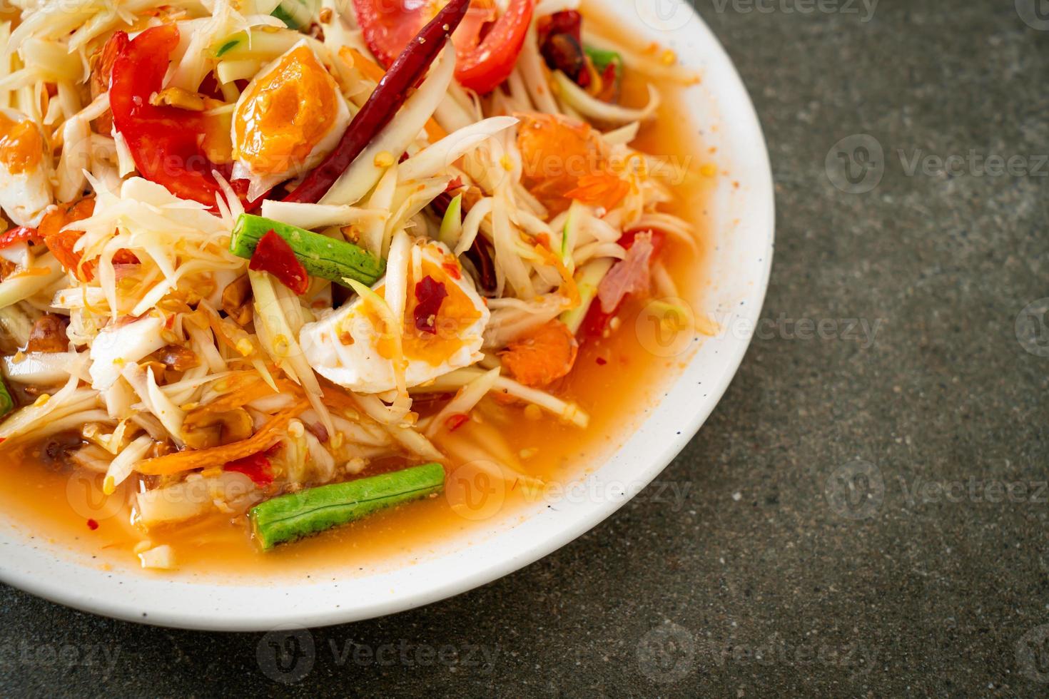 som tum - salade de papaye verte épicée thaï aux œufs salés photo