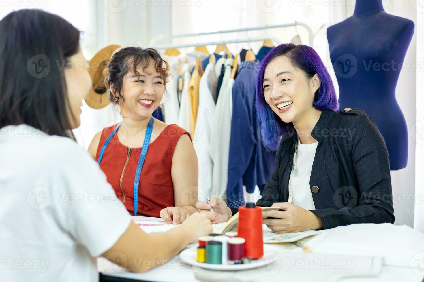 équipe de à la mode free-lance couturières et client choisir conception et pantone pour Nouveau Douane robe tandis que travail dans artistique atelier studio pour mode conception et Vêtements affaires industrie photo