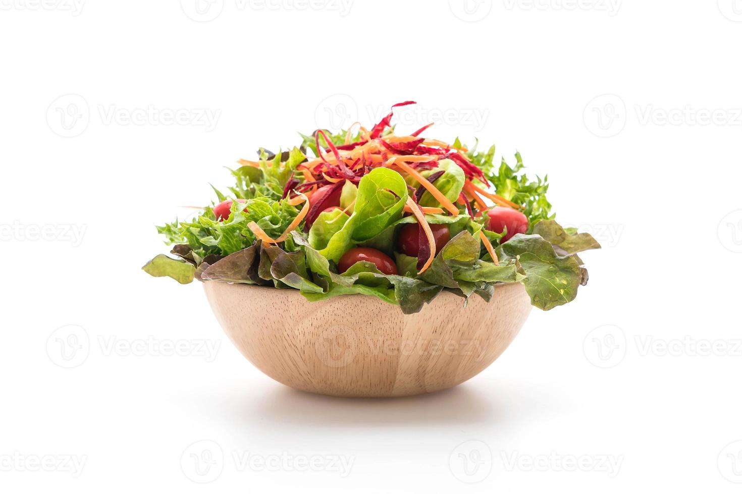 salade mixte dans un bol en bois sur fond blanc photo