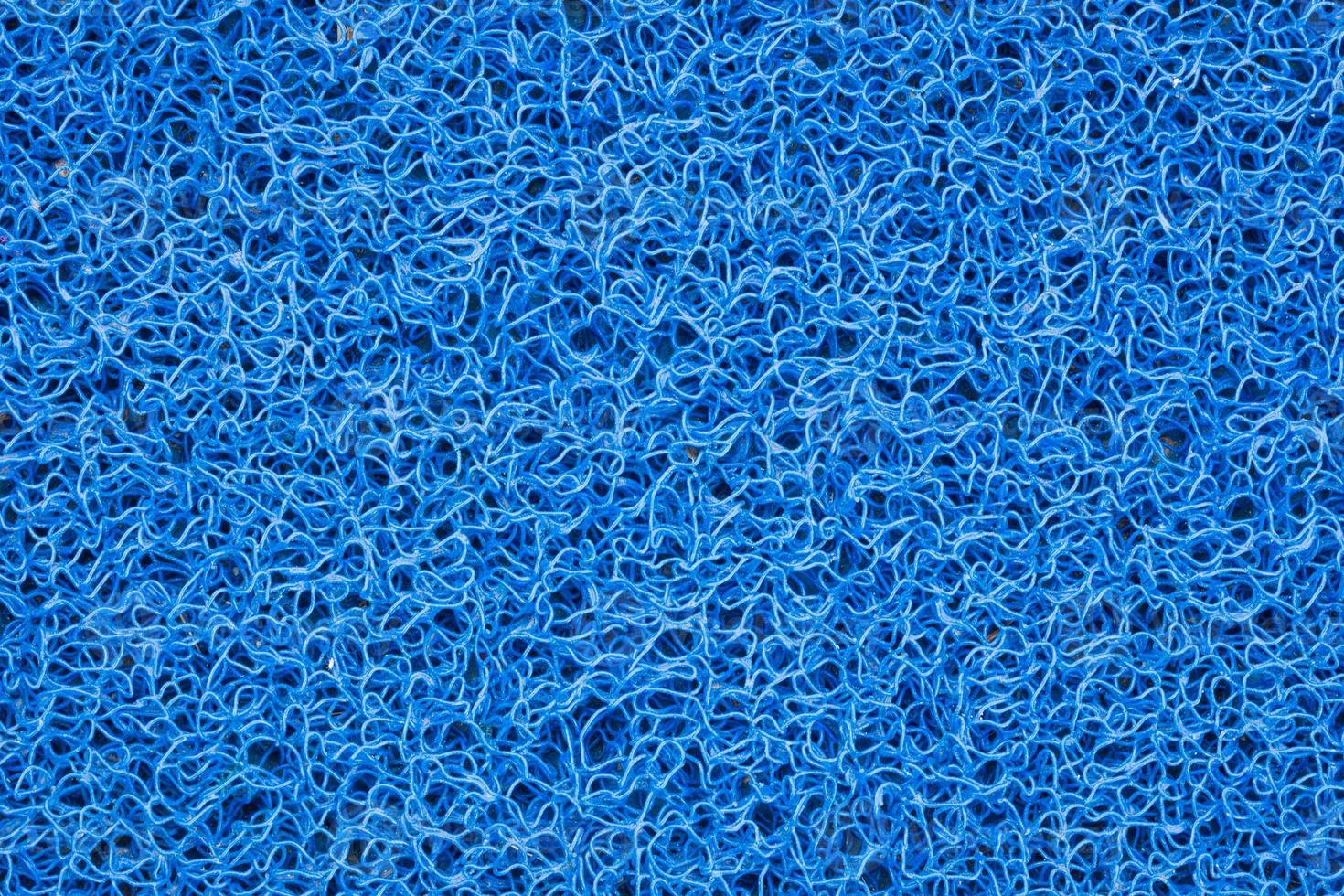 fond de tapis bleu ou de grattoir à pied ou de texture de tapis de porte photo