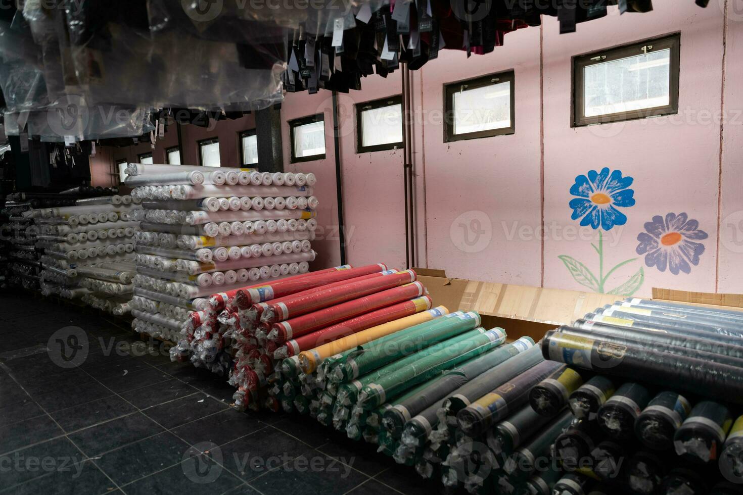 intérieur de un industriel entrepôt avec en tissu Rouleaux échantillons. petit affaires textile coloré entrepôt. photo