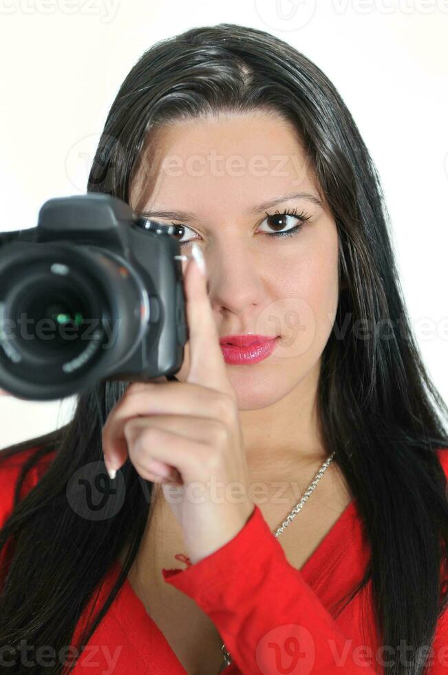 jeune femme tenant un appareil photo à la main prenant une photo isolée