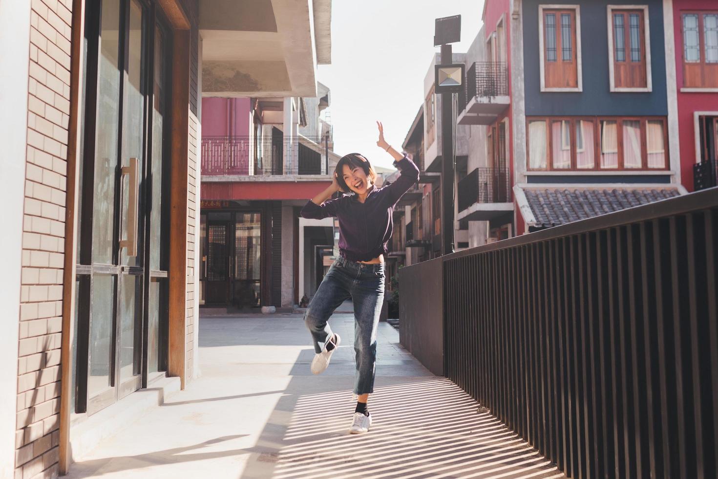 heureuse jeune femme asiatique écoutant de la musique avec des écouteurs photo