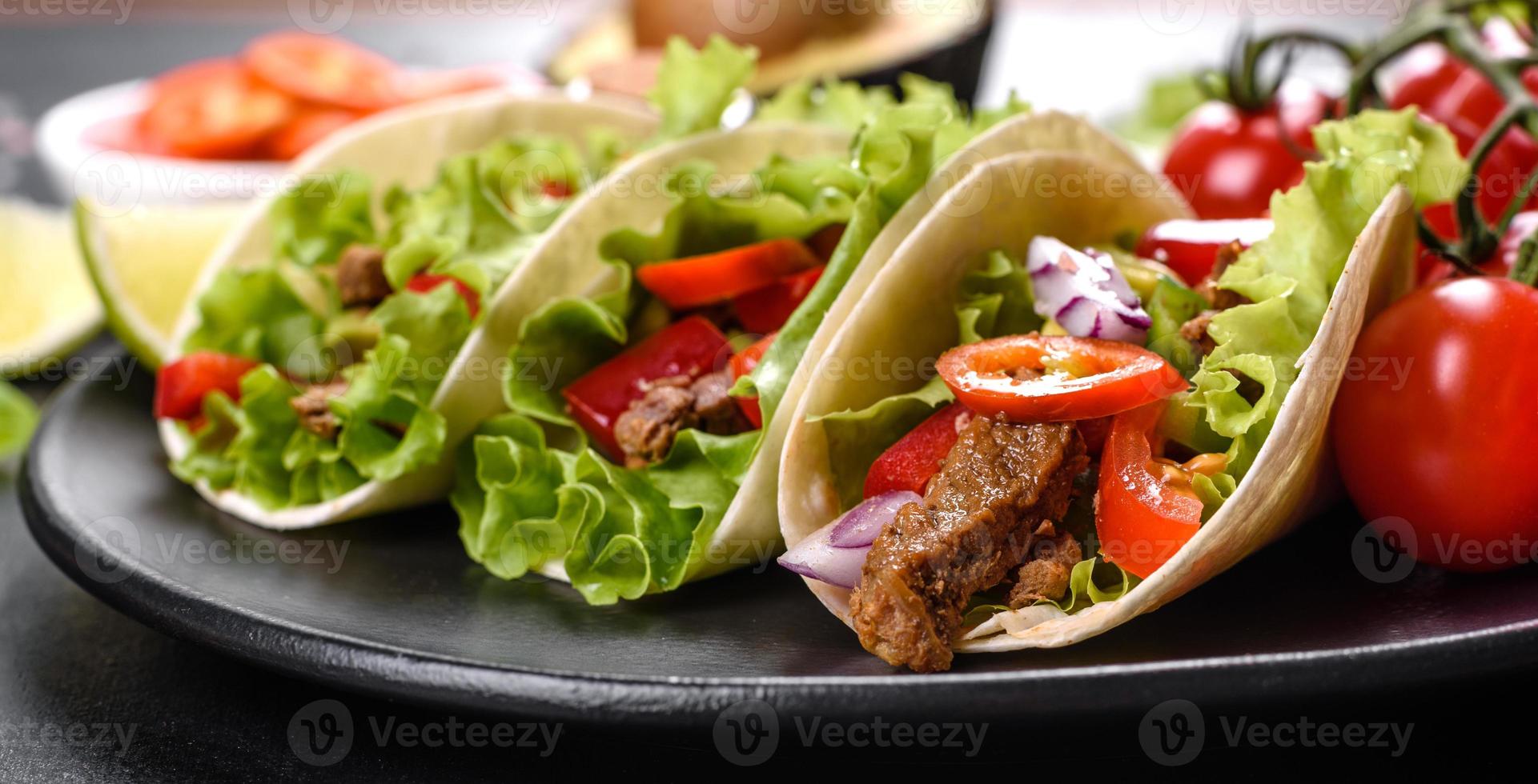 tacos mexicains avec boeuf, tomates, avocat, oignon et sauce salsa photo