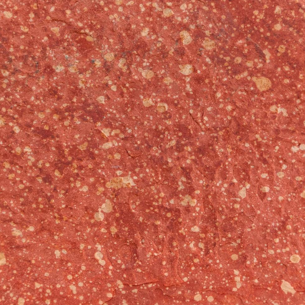 fond de texture de pierre rugueuse rouge. photo