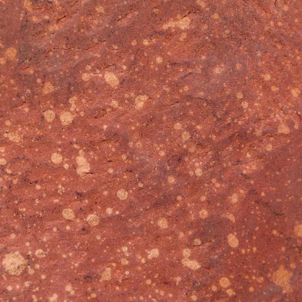 fond de texture de pierre rugueuse rouge. photo