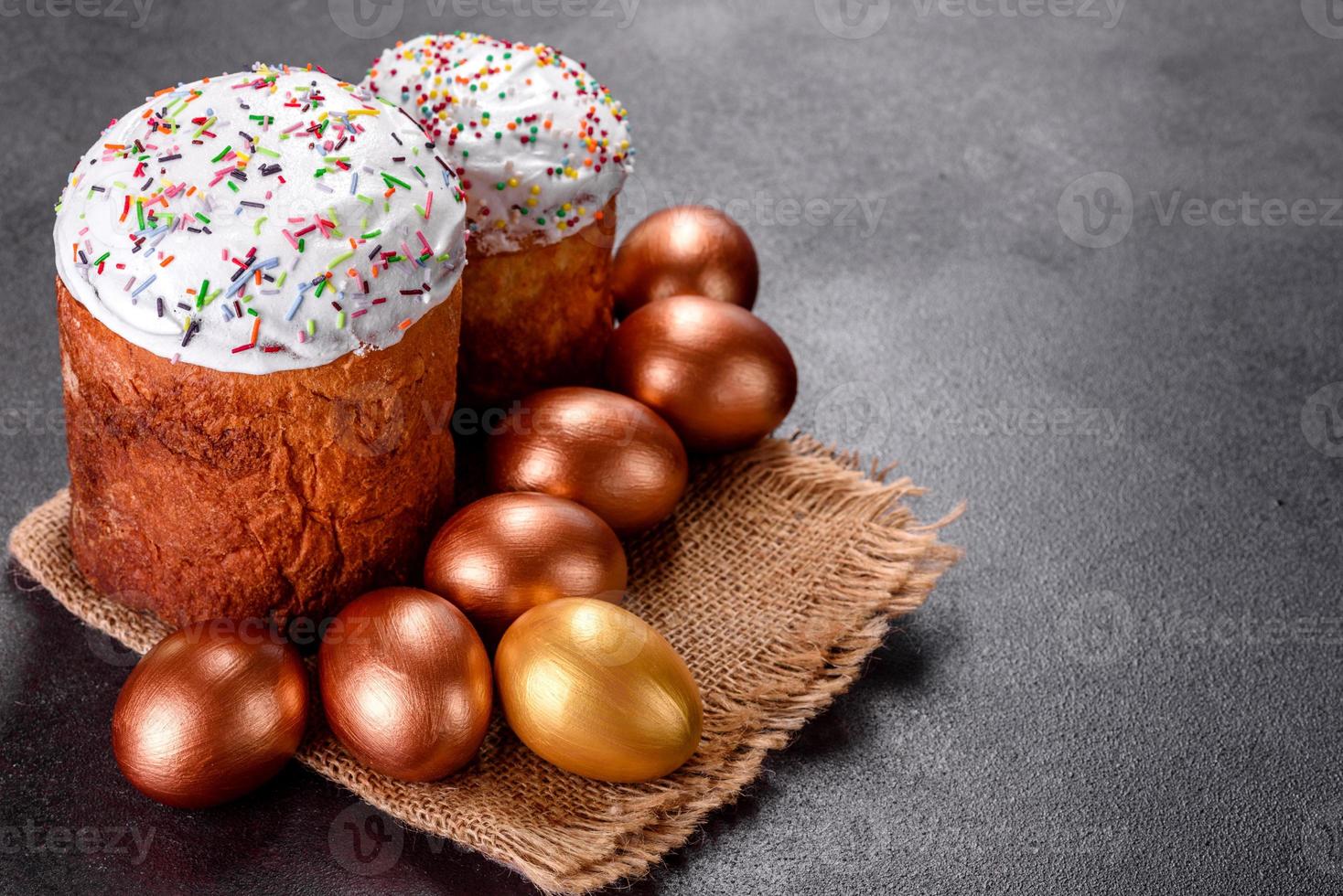 oeufs de pâques or et bronze et gâteau de pâques sur fond sombre photo