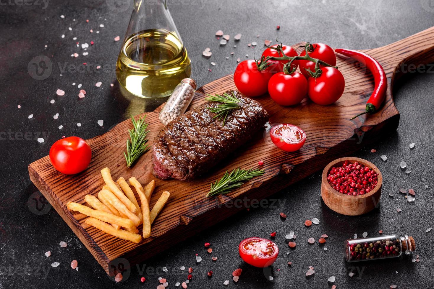 steak de faux-filet avec pommes de terre, oignons et tomates cerises photo