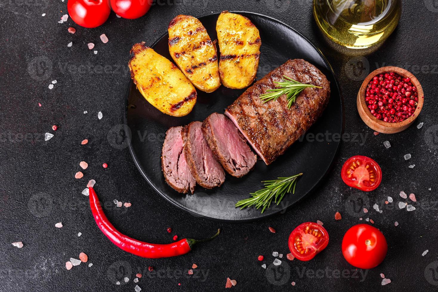 steak de faux-filet avec pommes de terre, oignons et tomates cerises photo