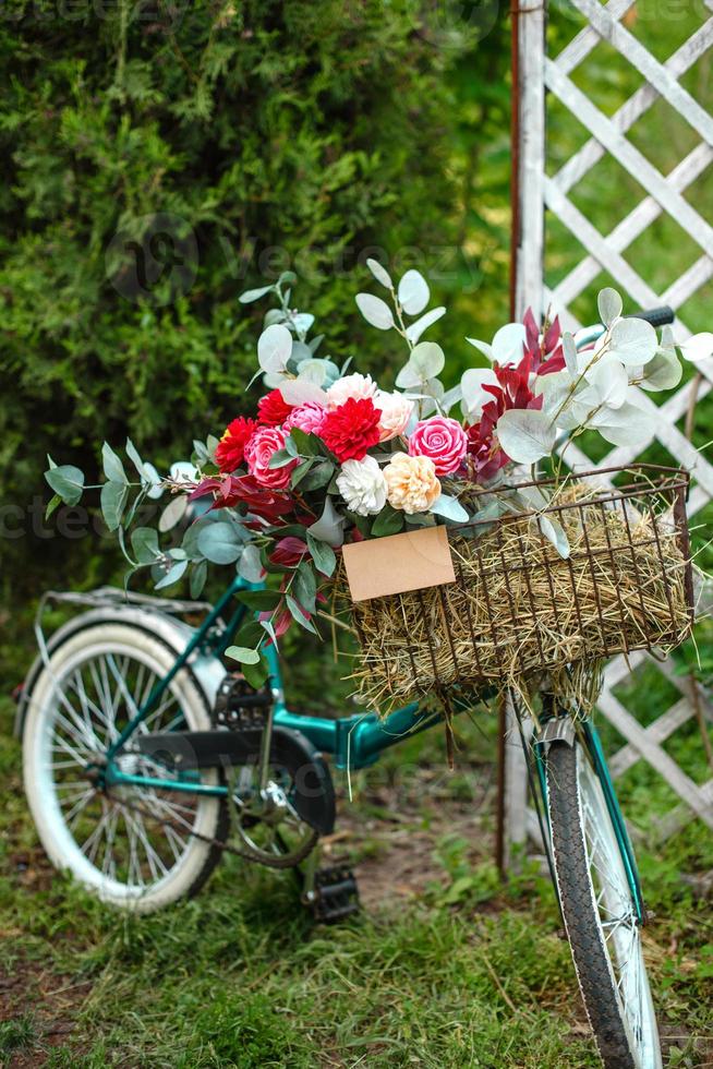 beau vélo avec des fleurs dans un panier se dresse sur une avenue photo
