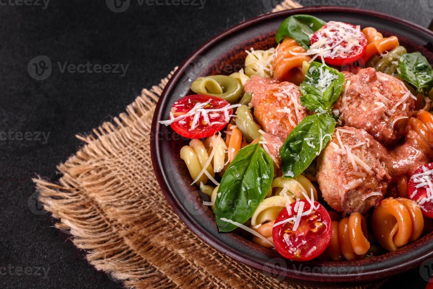 délicieuses pâtes fraîches aux boulettes de viande, sauce, tomates cerises et basilic photo