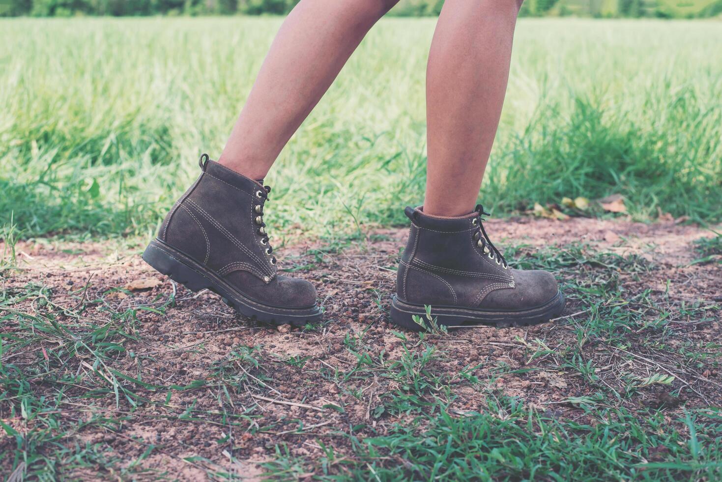 jeune femme d'aventure pieds marchant sur du gravier dans le parc. photo