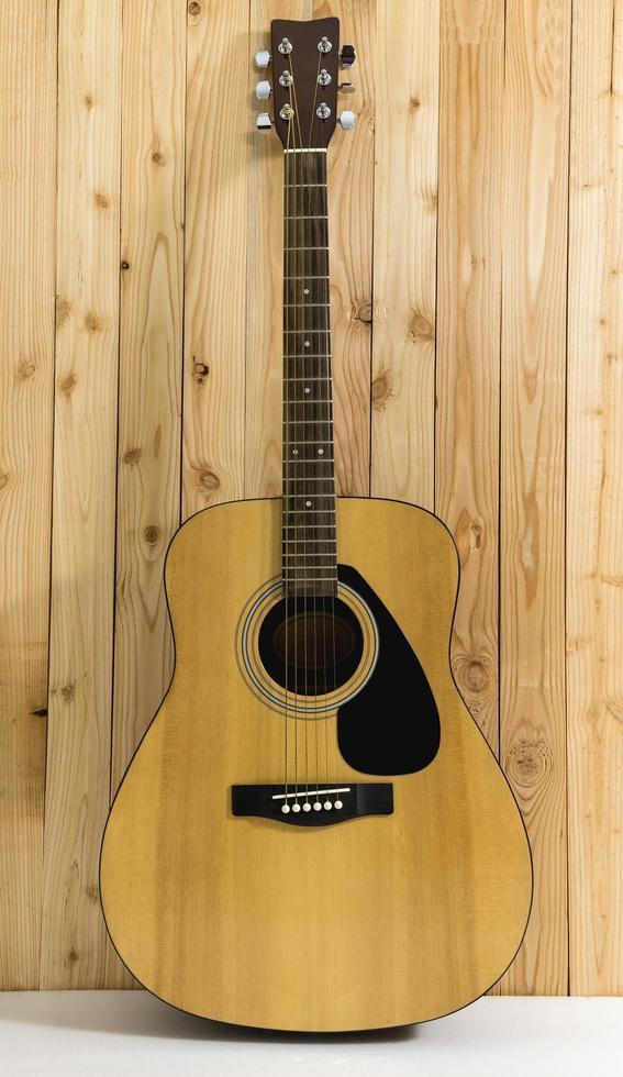 la guitare est droite avec un mur en bois photo