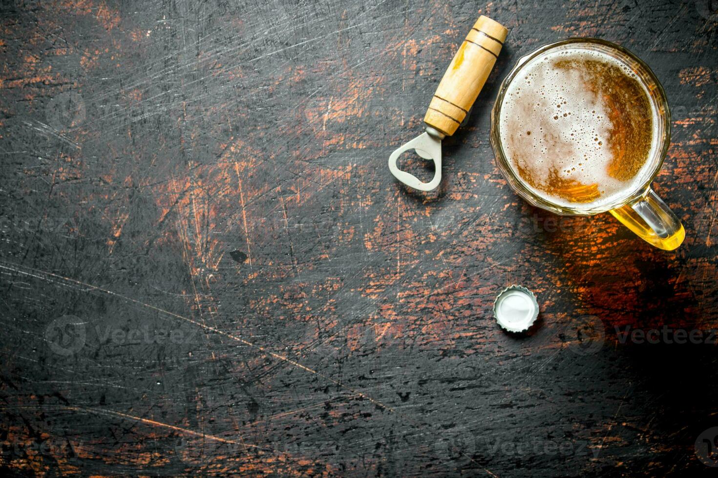 Bière dans une verre tasse et ouvreur. photo