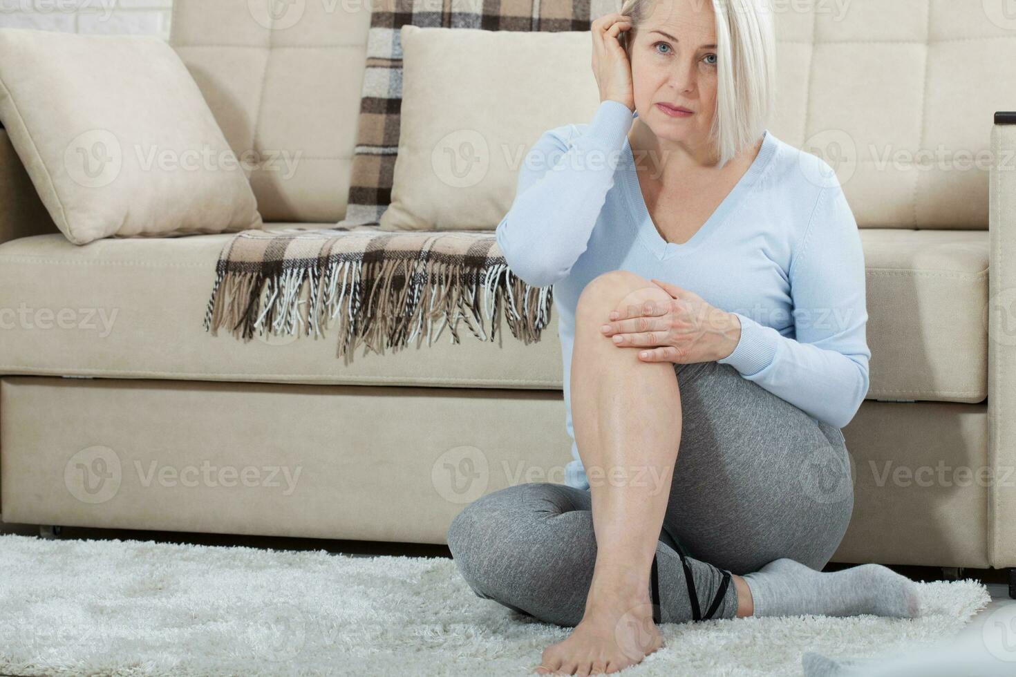 âge moyen femme Souffrance de douleur dans jambe à maison, fermer. physique blessure concept. photo