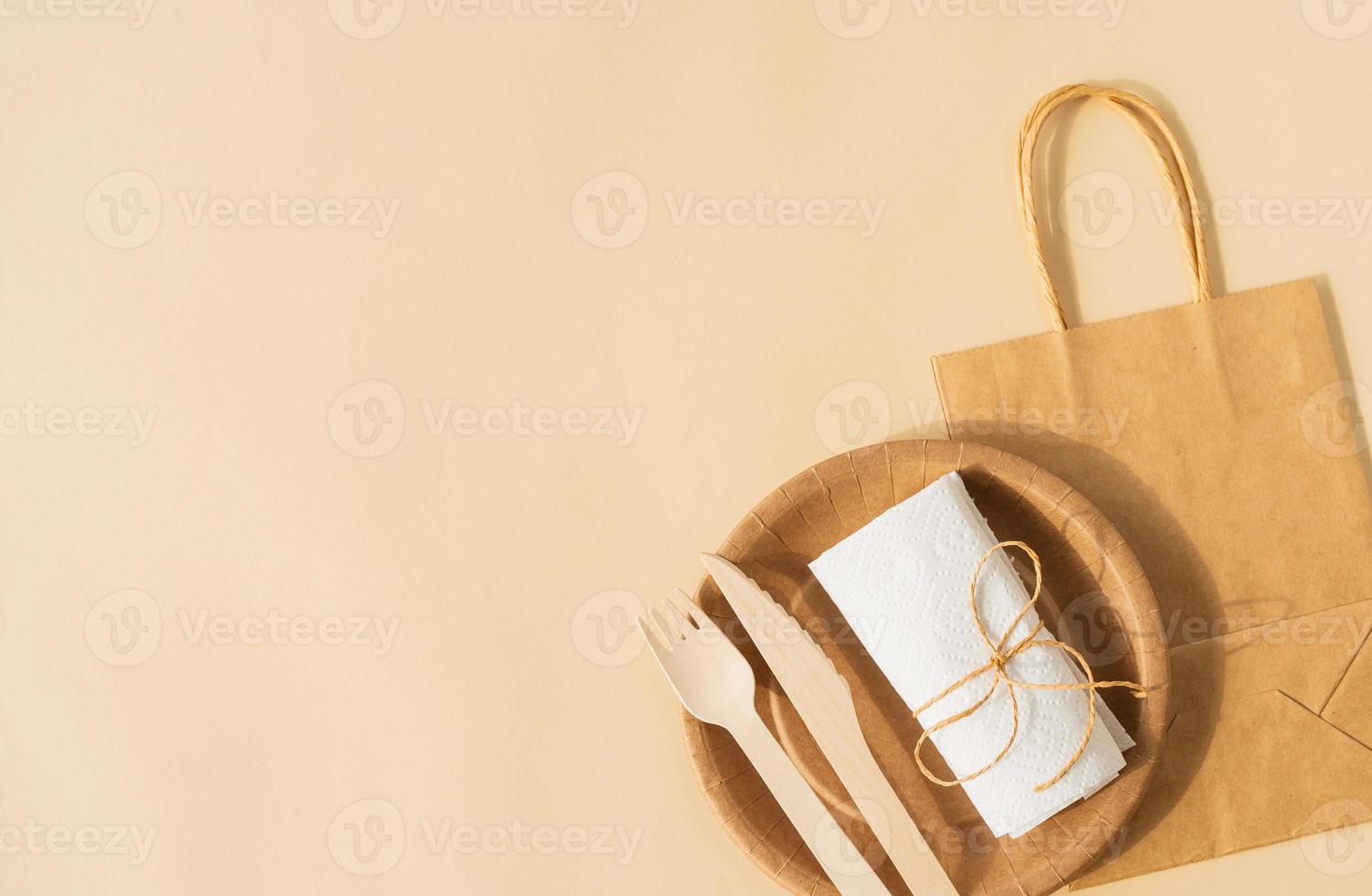 sac jetable et vaisselle tasse, assiette et fourchette en bois, couteau photo