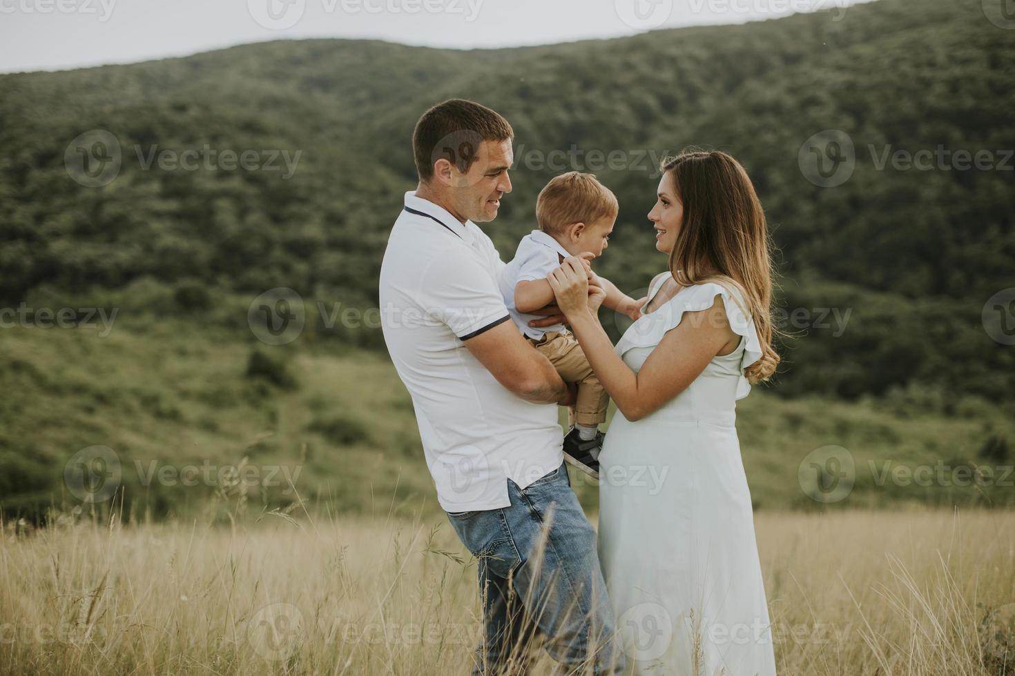 jeune famille avec mignon petit garçon s'amusant à l'extérieur sur le terrain photo