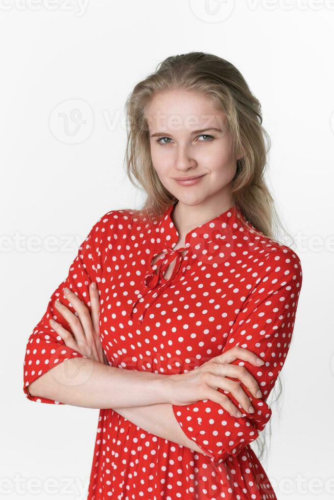 portrait de sincère souriant Jeune femme bras franchi plus de poitrine à la recherche à caméra, blanc Contexte photo