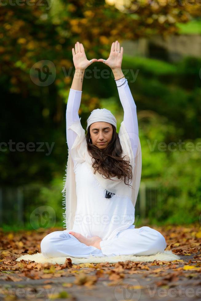 dans le parc d'automne, une jeune femme pratique le yoga seule photo