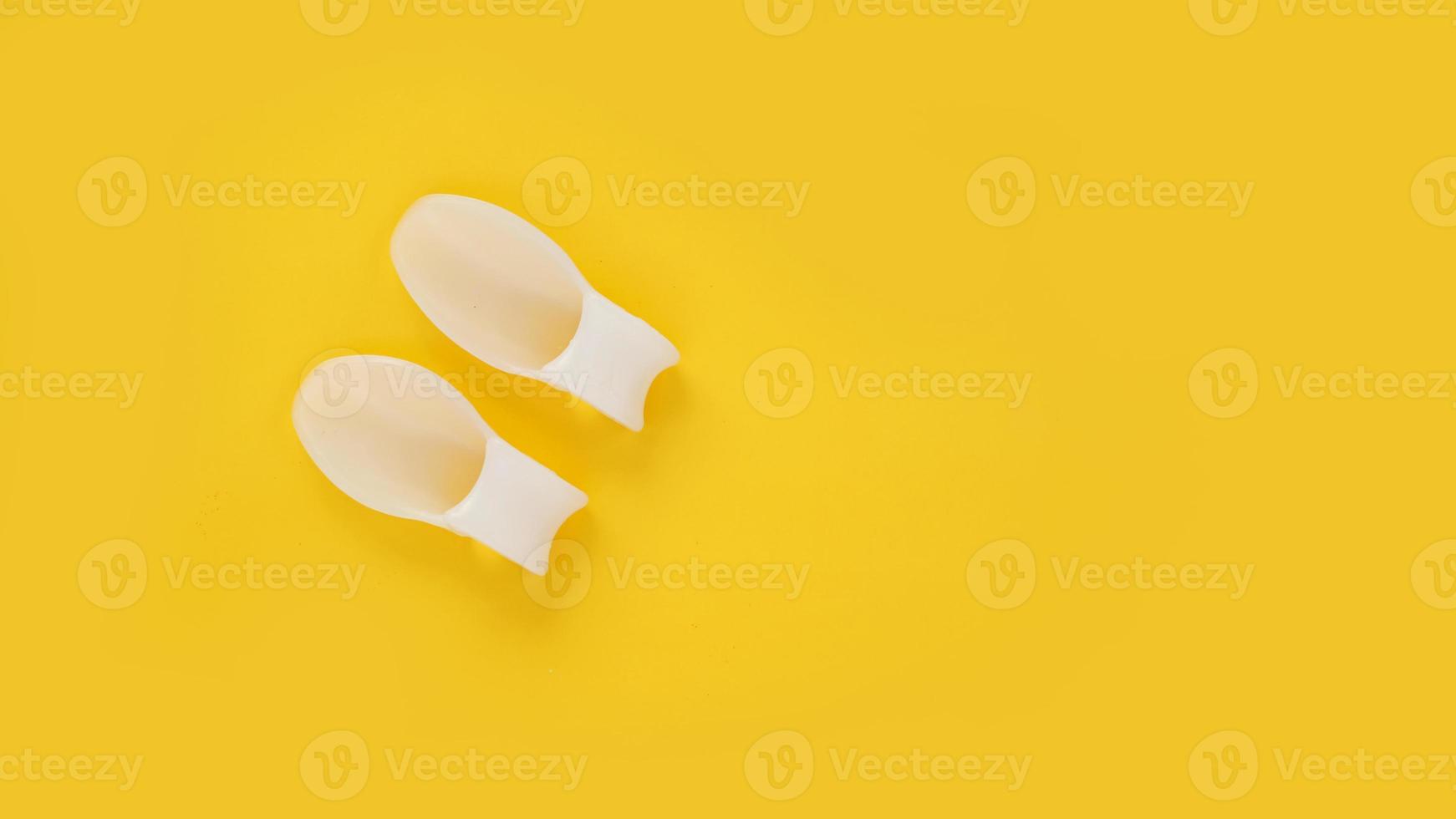 diviseur de doigt en silicone blanc sur fond jaune photo