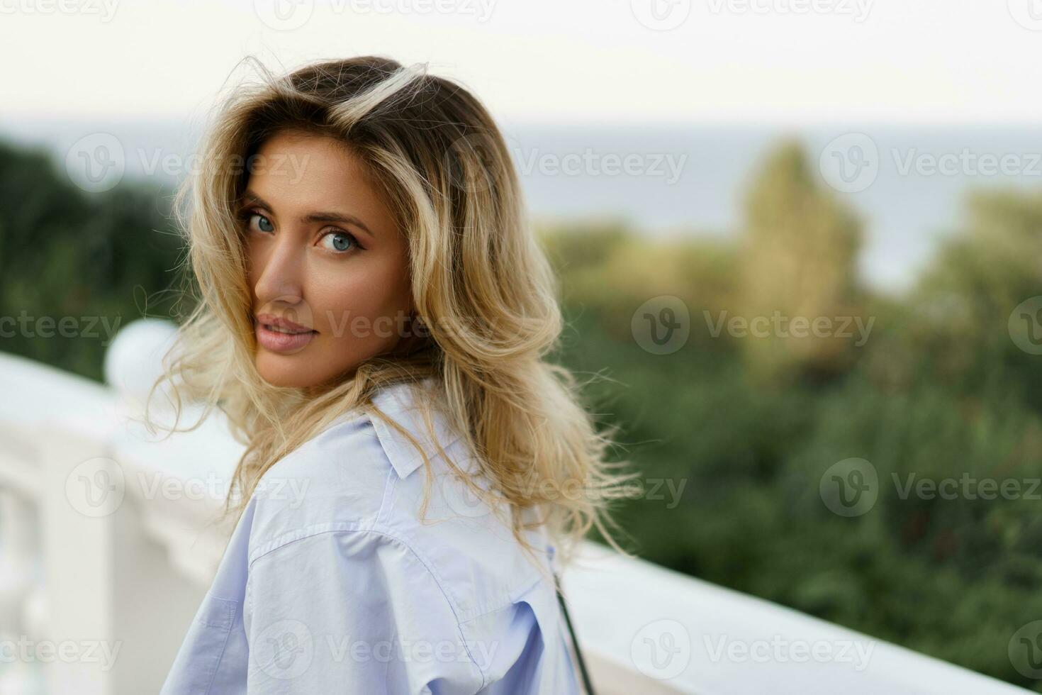 portrait de magnifique charmant blond femme avec parfait peau et ondulé Cheveux posant Extérieur pendant vacances dans L'Europe . photo
