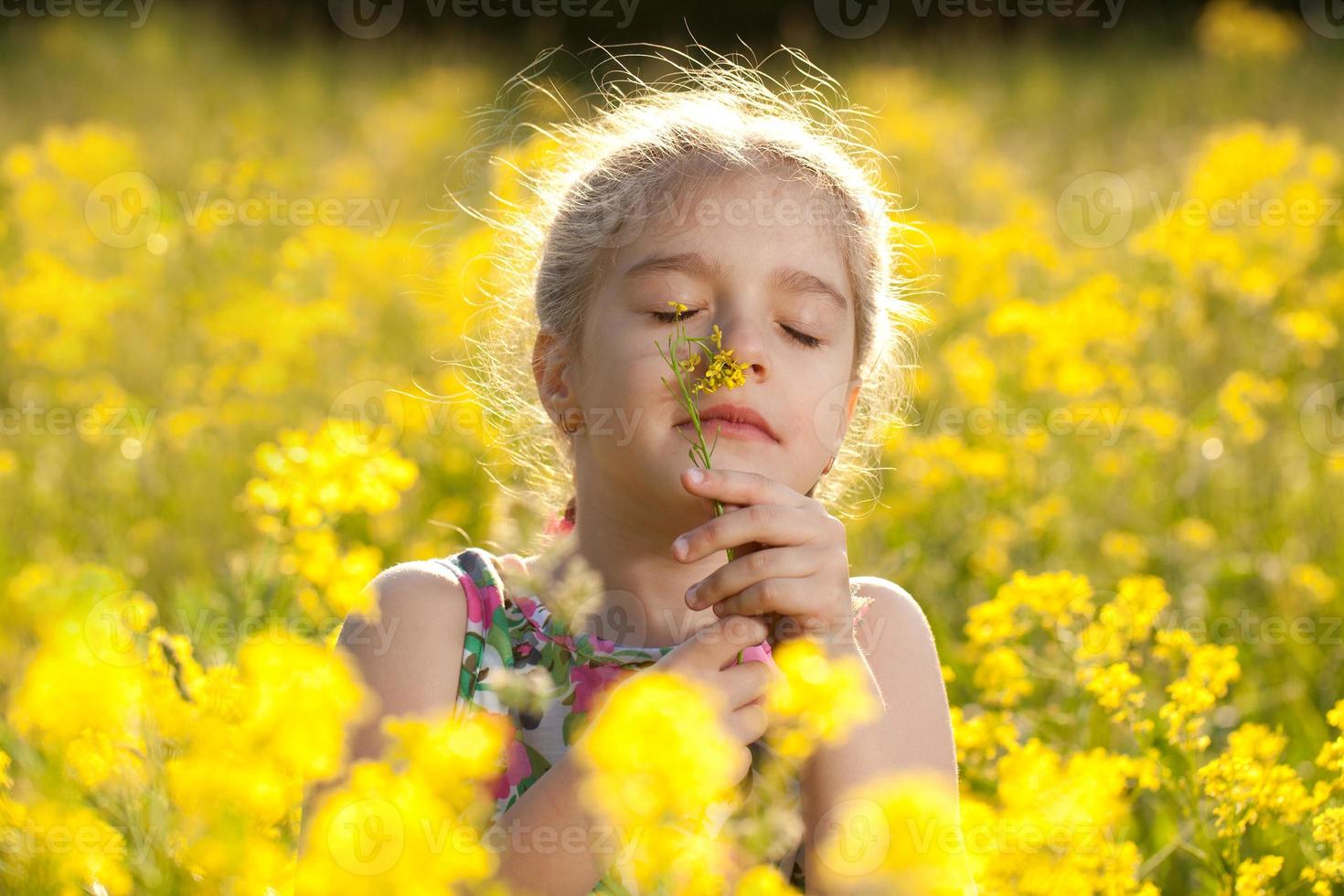 petite fille aime l'odeur des fleurs photo