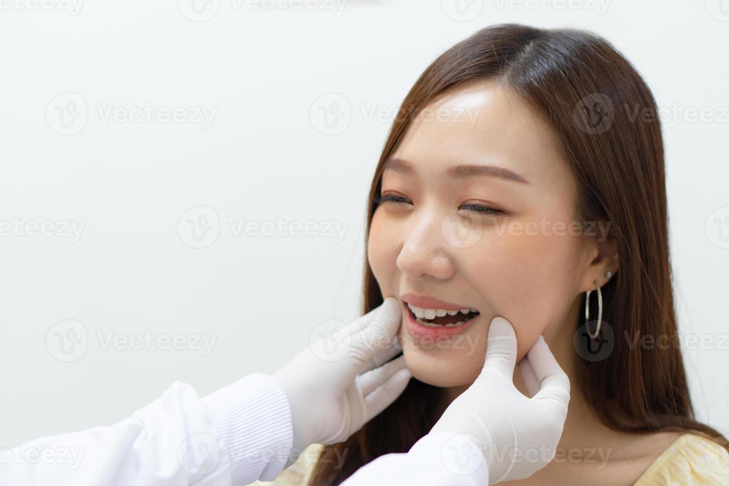 dentiste examinant le menton et la mandibule du patient avant la chirurgie photo