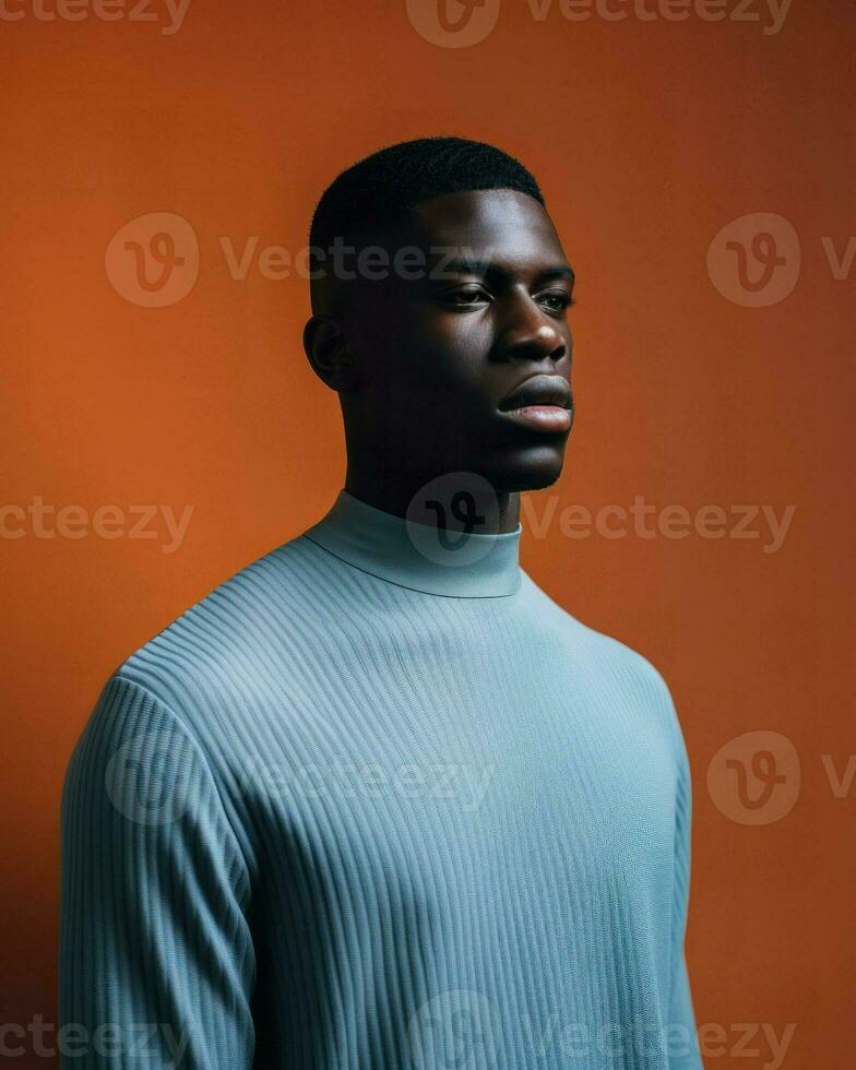un africain homme portant une bleu chemise est représenté contre une foncé Orange Contexte dans le image.. génératif ai photo