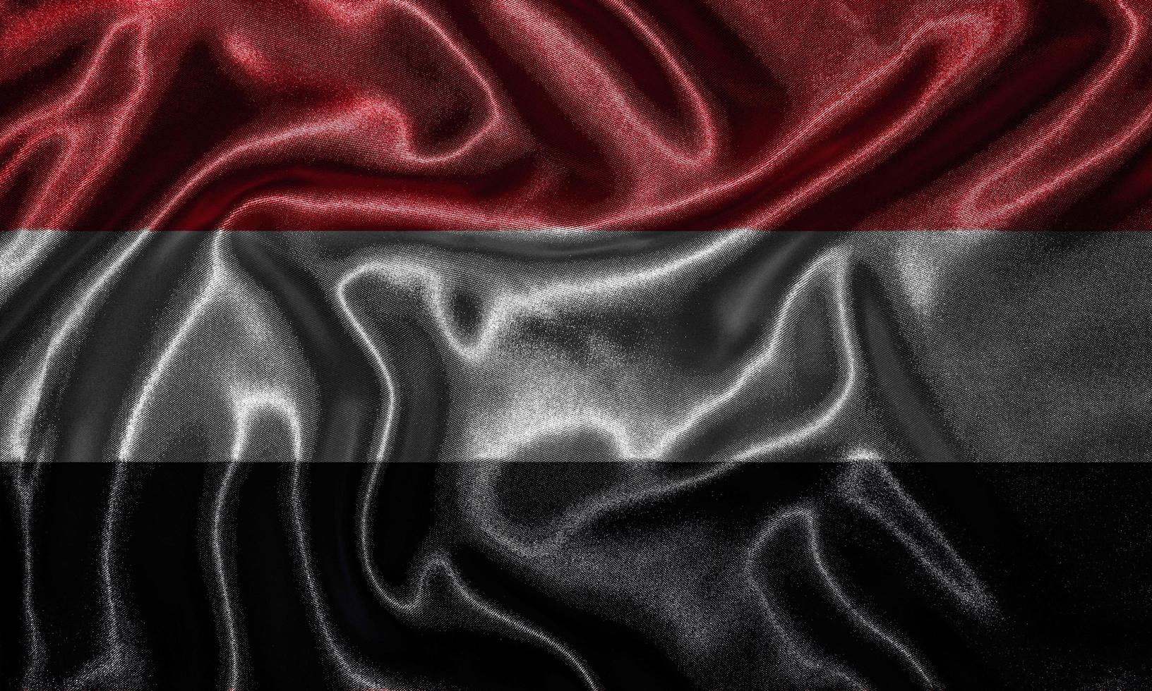 papier peint par drapeau yéménite et drapeau ondulant par tissu. photo