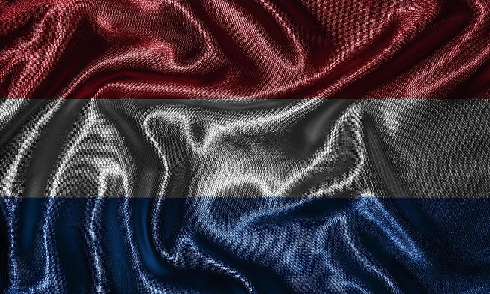 papier peint par drapeau des Pays-Bas et drapeau ondulant par tissu. photo