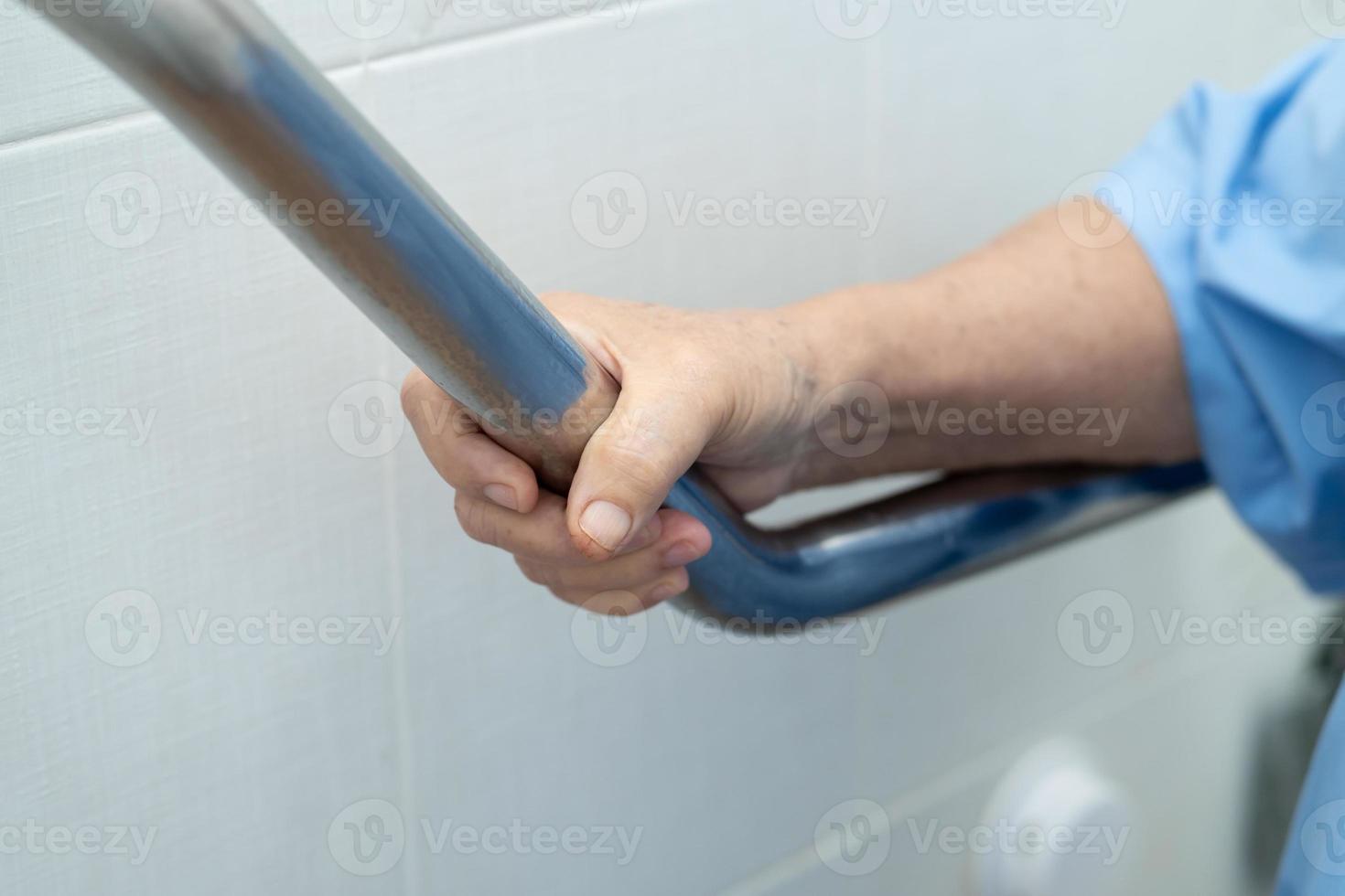 femme senior asiatique patient utiliser toilettes salle de bain poignée sécurité photo