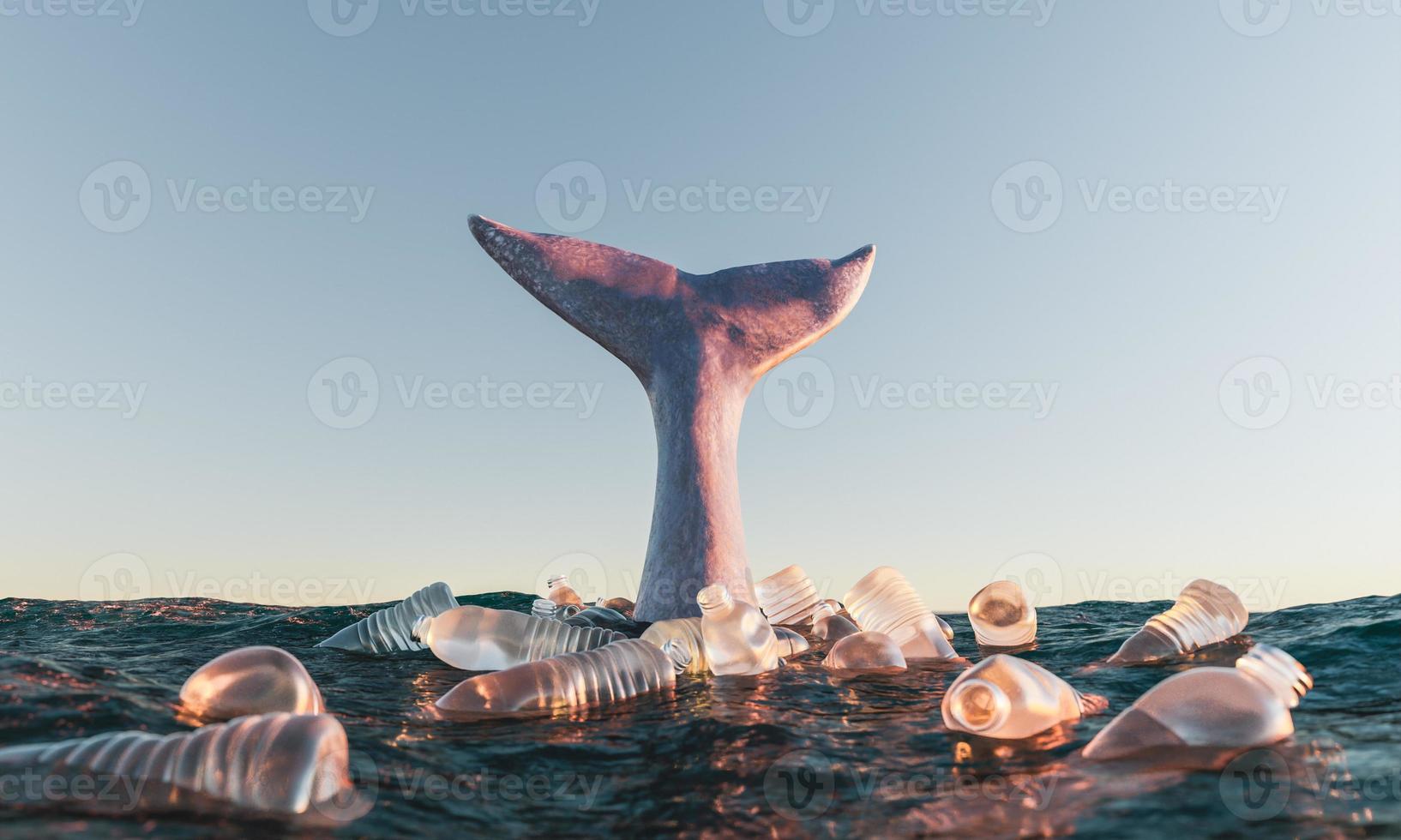 queue de baleine dans l'océan entourée de bouteilles en plastique photo