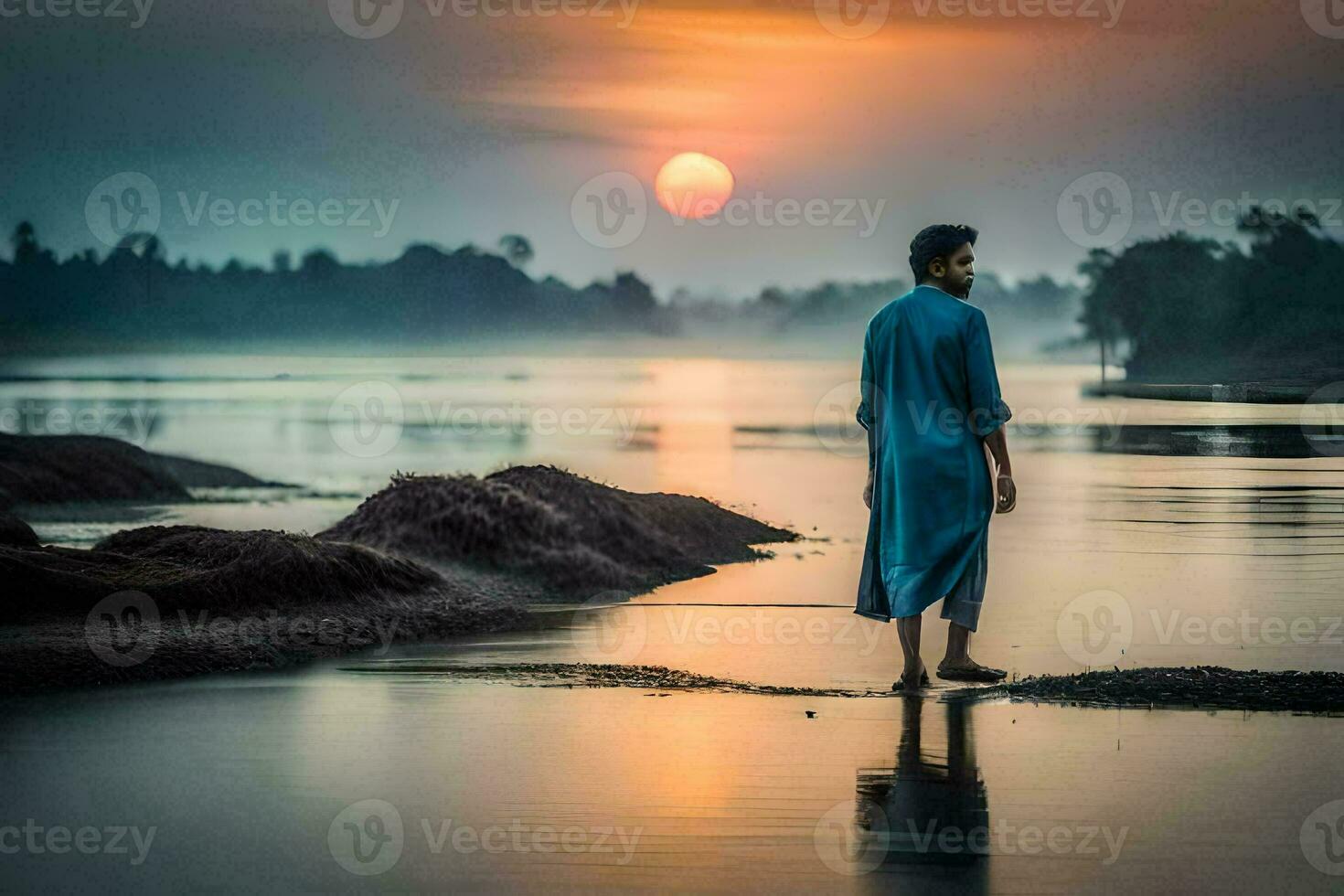 une homme dans bleu robe permanent sur le rive de une rivière à le coucher du soleil. généré par ai photo