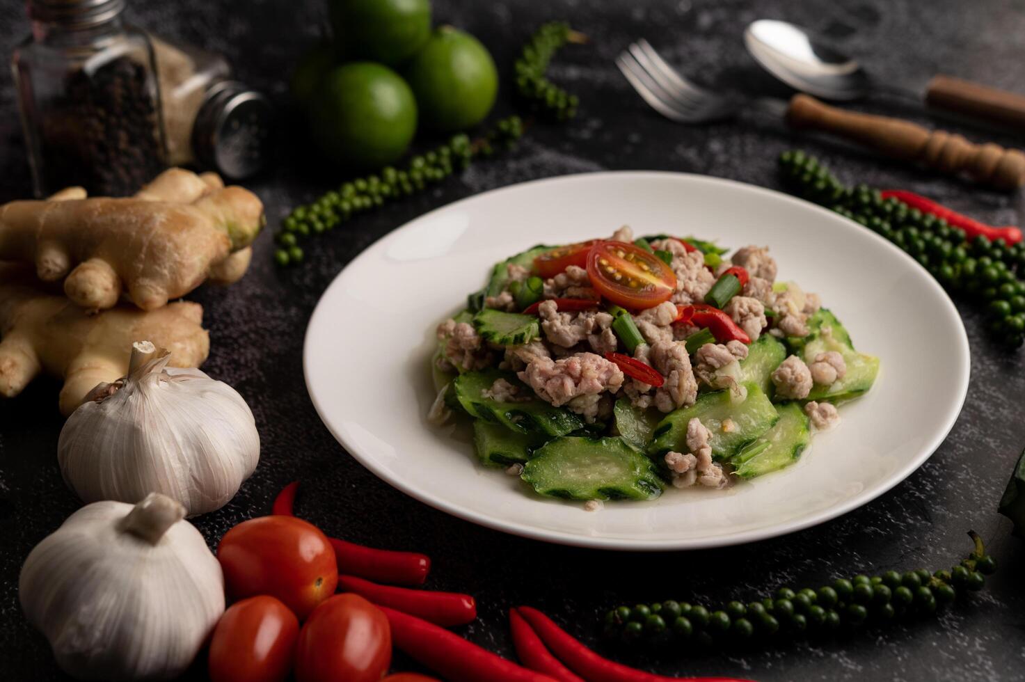 courgettes sautées avec du porc émincé dans une assiette blanche photo