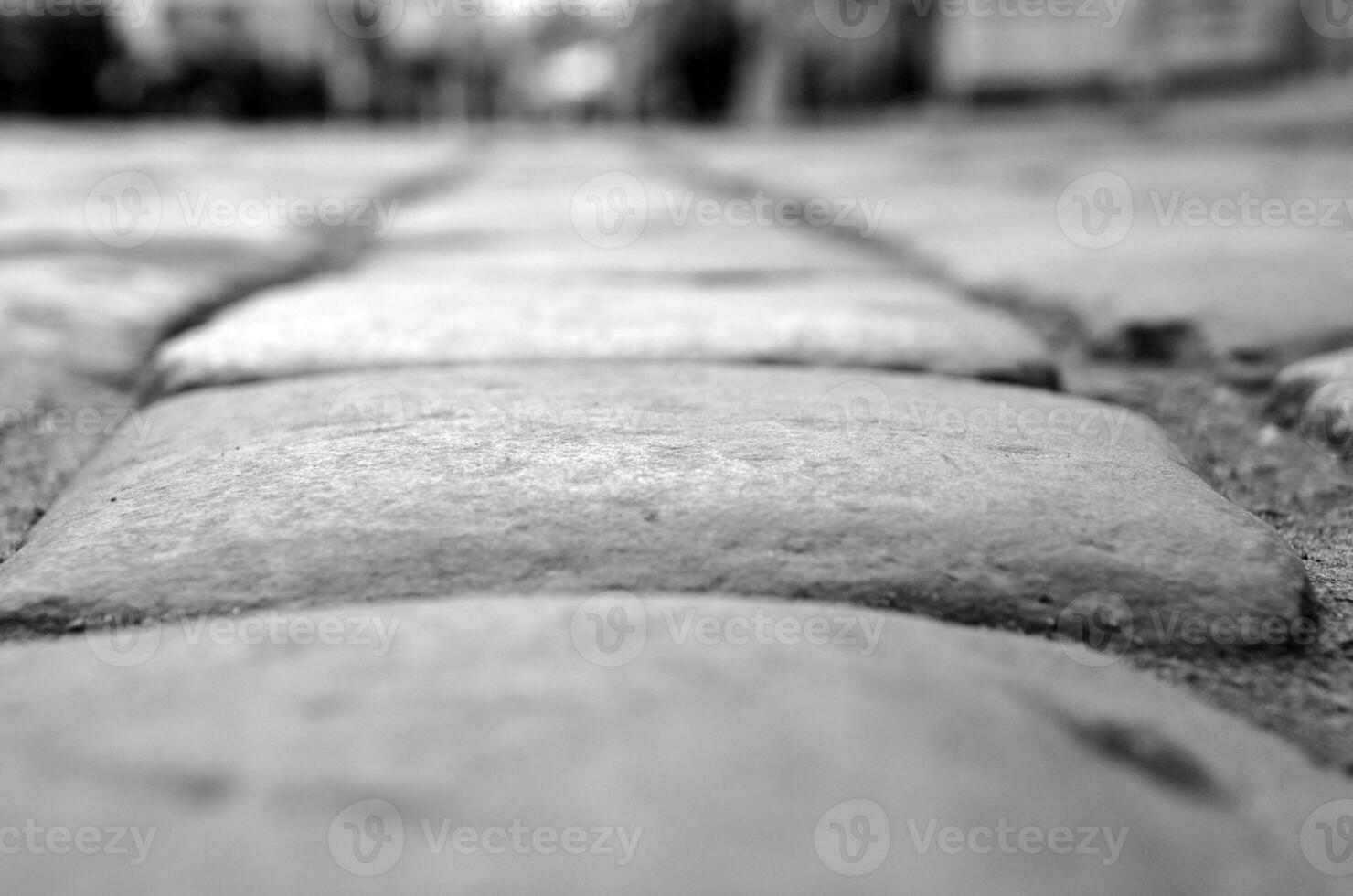 des pierres de une pavé route, route proche vue abstrait noir et blanc Contexte photo